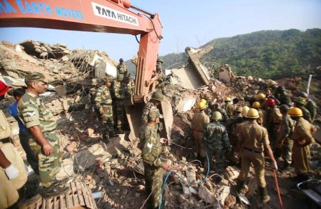 Indian army soldiers and fire officials look for survivors from the debris of a building that collapsed in Canacona, about 70 kilometers (44 miles) from Goa state capital Panaji, India on Sunday.