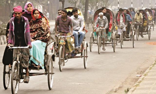 Commoners are going to their respective destination riding on rickshaws due to non-availability of passenger buses during hartal called by BNP-led 18-party alliance. The snap was taken from the city's Agargaon area on Monday.