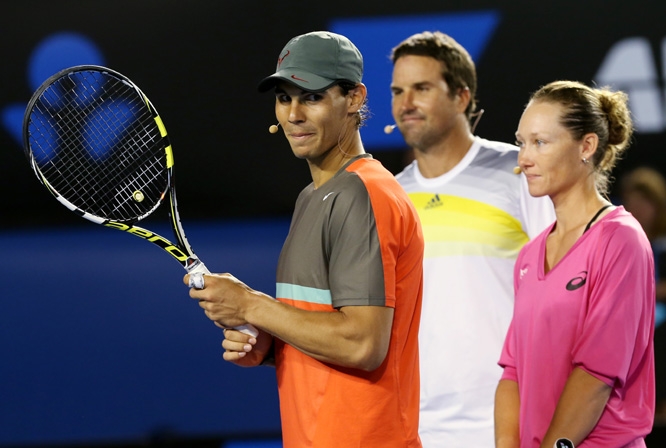 Spain's Rafael Nadal (left) stands with Australia's Pat Rafter and Samantha Stosur during an exhibition match on Kids Tennis Day ahead of the Australian Open tennis championship in Melbourne, Australia on Saturday.