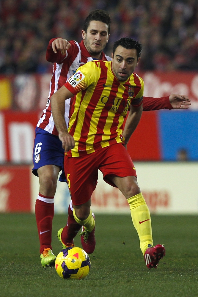 Barcelona's Xavi Hernandez in action with Atletico's Koke during a Spanish La Liga soccer match between Atletico de Madrid and FC Barcelona at the Vicente Calderon stadium in Madrid, Spain on Saturday.