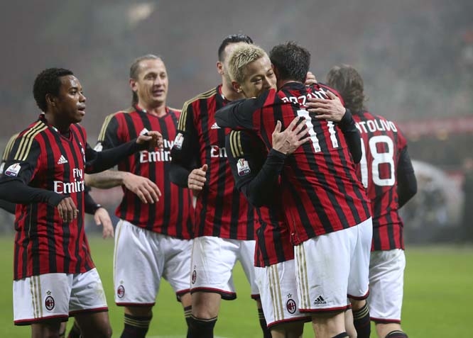 AC Milan forward Giampaolo Pazzini (right) celebrates with his teammate Keisuke Honda (fourth from right) of Japan after scoring during the Italian Cup soccer match between AC Milan and Spezia at the San Siro stadium in Milan, Italy on Wednesday.