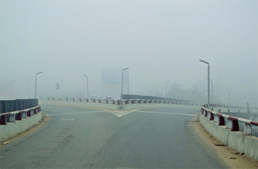 Appalling condition: The capital enveloped in dense fog and chilly cold caused disruption in the movement of vehicles on Friday. This photo was taken from Kuril Flyover in morning hours.