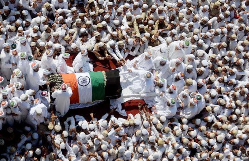 Indian Bohra Muslims gather around the coffin of their spiritual leader Syedna Mohammed Burhanuddin during his funeral procession in Mumbai on Saturday.