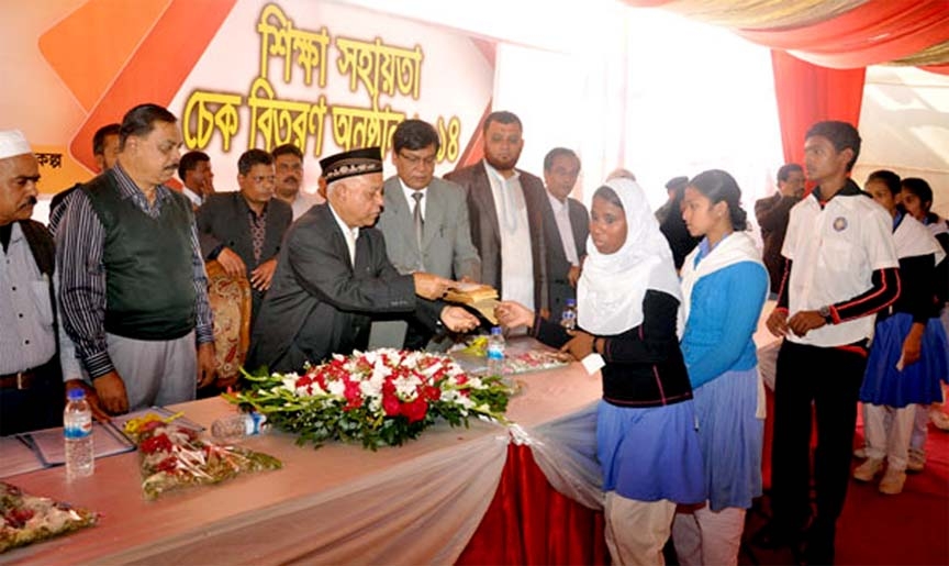 CCC Mayor M Monzoor Alam distributing education assistance cheque to the slum students at a function in Chittagong yesterday.