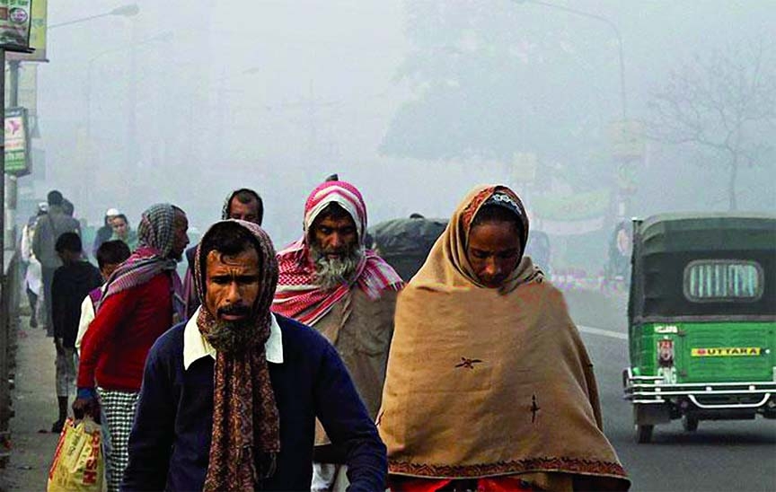 Cold-hit workers on their way to workplace amid dense fog early in the morning in the capital. This photo was taken from Equria bridge on Saturday.
