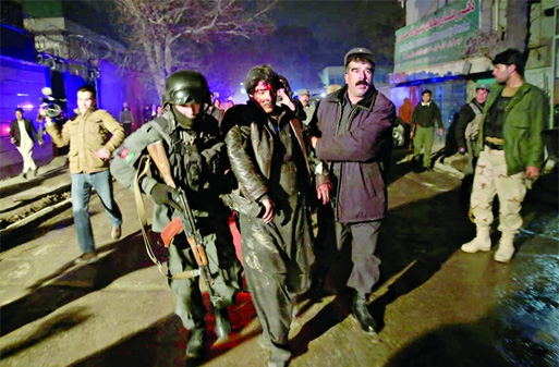 Afghan security forces assist an injured man at the site of an explosion in Kabul, Afghanistan on Friday. Police said a suicide bomber attacked a Kabul restaurant popular with foreigners, officials.