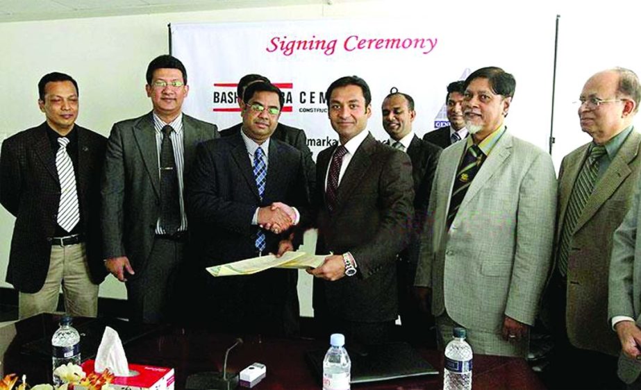 Sayem Sobhan, Managing Director of Basundhara Group and M Saiful Kabir, Managing Director of Genetic Limited exchanging documents after signing an agreement at East West Media Centre on Sunday. Genetic Ltd, a leading infrastructure development company, wi