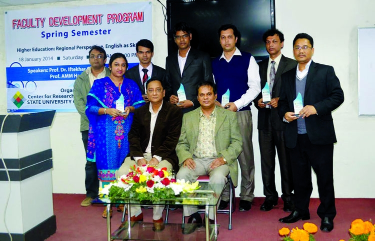 Dr. A M Shamim, President of the Board of Trustees of the State University of Bangladesh (SUB) and Prof. Dr. Iftekhar Ghani Chowdhury, Vice- Chancellor, SUB are seen with the recipients of 'Faculty of the year award 2013' at its auditorium in the city