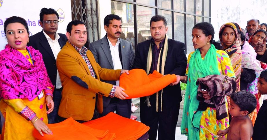 District Chairperson and Charter President of Lions Club of Dhaka Dilkusha Green Ln. Mohammad Mizanur Rahman handing over blankets among the cold stricken people recently.