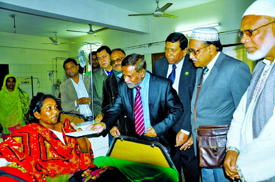 President of Bangladesh Specialized Textiles Mills and Powerloom Industries Association Azizul Haque giving Taka two lakh as grant to 20 arson victims who were wounded during siege enforced by BNP-led 18-party alliance in the Burn Unit of Dhaka Medical Co
