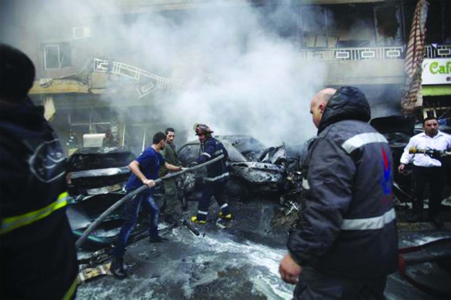 Firefighters extinguish a fire at the site of an explosion in the Haret Hreik area, in the southern suburbs of the Lebanese capital Beirut on Tuesday.