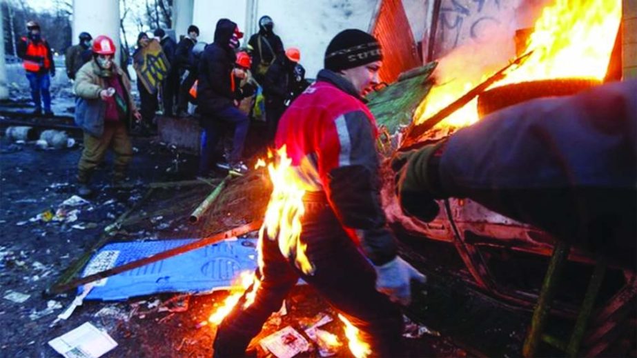 A protester catches fire during clashes with police in Kiev on Monday The protesters are demanding the resignation of President Yanukovych and early elections.