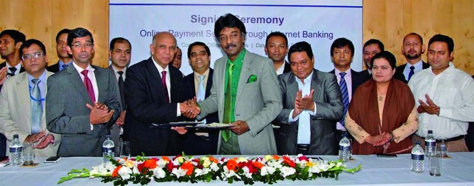 Aminul Islam, Managing Director (CC) of Bank Asia Ltd and Sayeeful Islam, Managing Director of Software Shop Limited exchanging agreed document on e-commerce payment system held at the bank's corporate office in the city on Tuesday.
