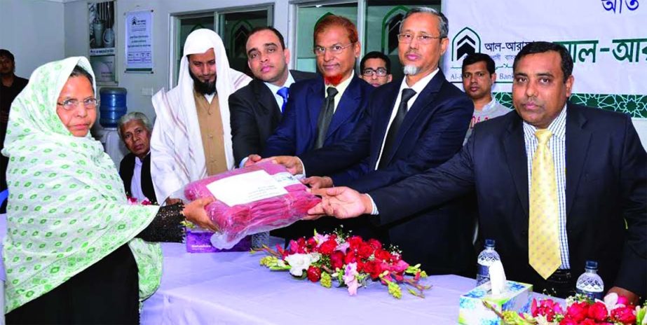 Mohammad Abdul Jalil, Deputy Managing Director of Al-Arafah Islami Bank Limited distributing blankets among the cold affected poor of the country organized by AIBL Daxminkhan branch, Dhaka recently.