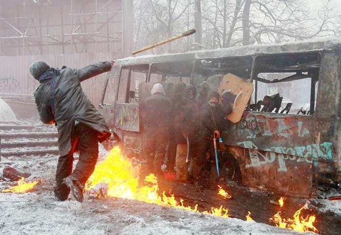 Protesters by a burning bus in Kiev, Ukraine (22 Jan 2014) Firebombs were thrown by both sides as the violence broke out.