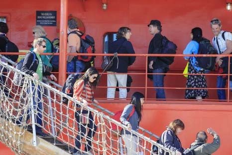 Passengers disembark from the Aurora Australis in Hobart, Australia on Wednesday following their rescue from a ship trapped in ice in the Antarctic. The ship rescued 52 passengers with the help of a helicopter from a Chinese ship on Jan. 2,