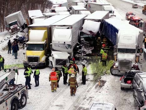 Emergency crews work at the scene of a massive pileup involving more than 40 vehicles, many of them semitrailers, along Interstate 94 Thursday.