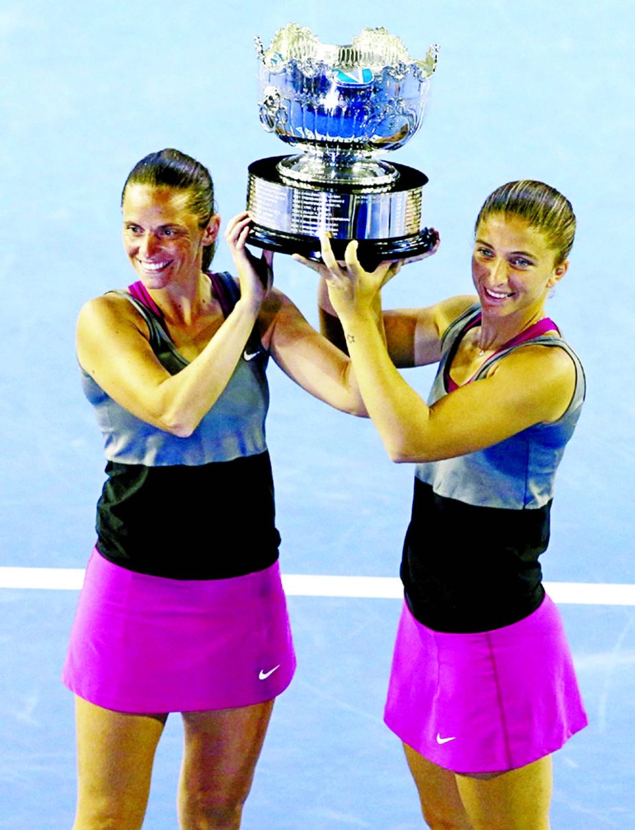 Italy's Sara Errani (right) and Roberta Vinci hold up the championship trophy after defeating Russia's Ekaterina Makarova and Elena Vesnina in their women's doubles final at the Australian Open tennis championship in Melbourne, Australia on Friday.
