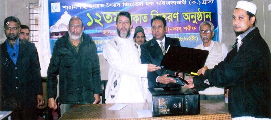 Pro-Vice Chancellor of Chittagong University Prof. Iftekharuddin Ahmed distributing computer from Shaheshah Syed Maizbhandari Ziaul Hoque Trust Zakat Fund among the poor Students recently.