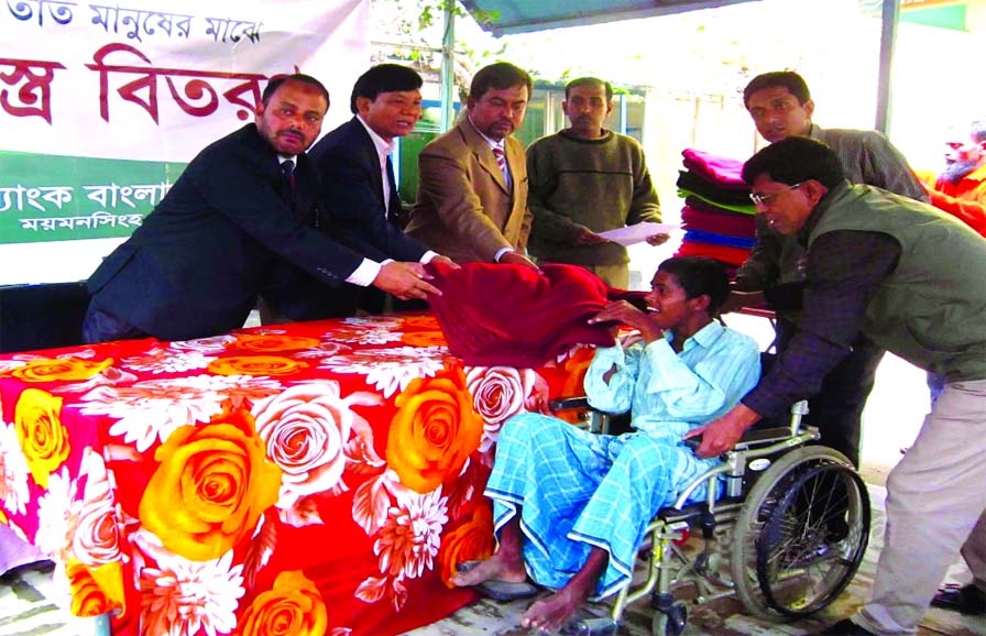 Islami Bank Bangladesh Limited Mymensingh branch distributing warm clothes among the destitute families of the town on Sunday.