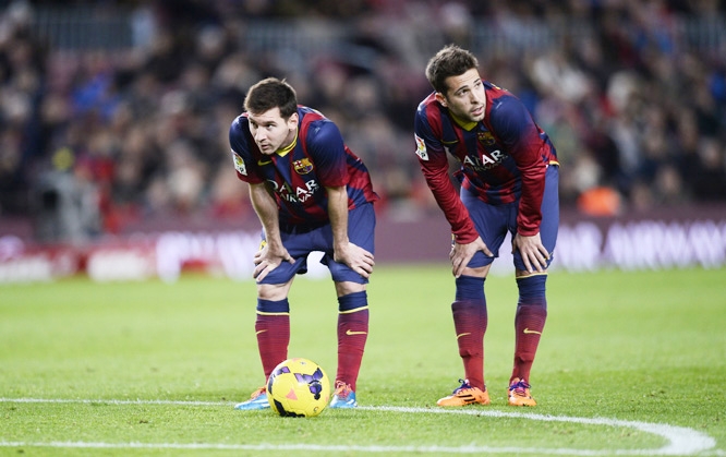 FC Barcelona's Lionel Messi from Argentina (left) and Jordi Alba look on during a Spanish La Liga soccer match against Malaga at the Camp Nou stadium in Barcelona, Spain on Sunday.