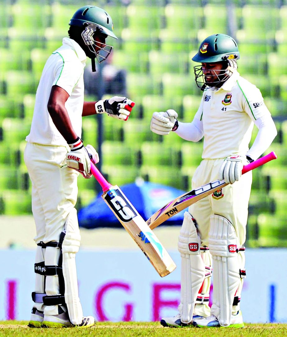 Sohag Gazi (left) greets skipper Mushfiqur Rahim after he hit his career's 13th Test half century on the first day of 1st Test between Bangladesh and Sri Lanka at the Mirpur Sher-e-Bangla National Cricket Stadium on Monday.