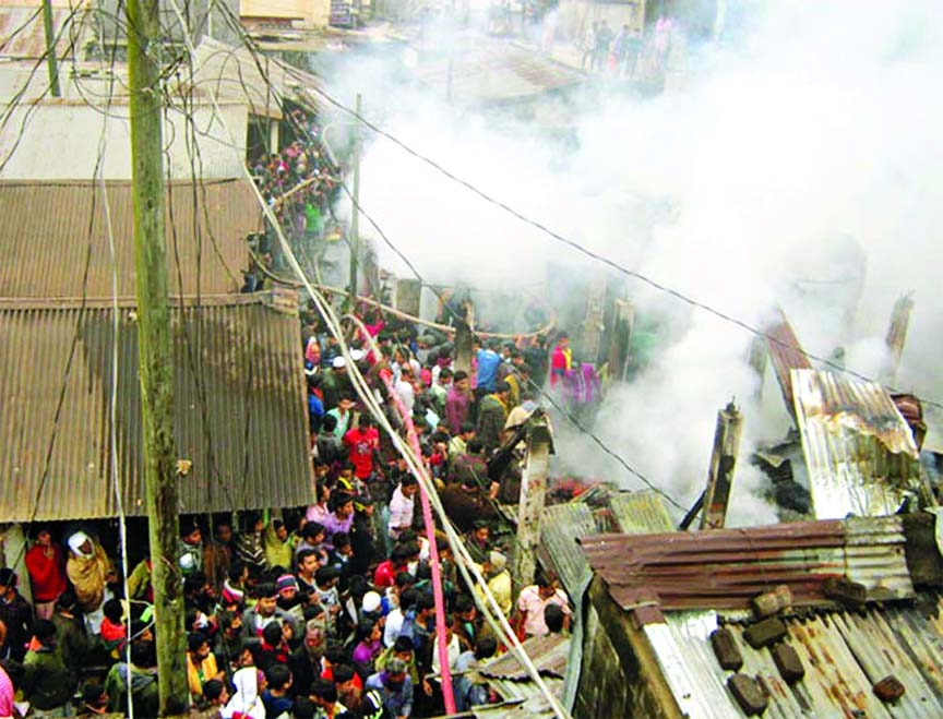 Fire fighters trying to douse the flame as devastating fire gutted the Fatikchhari slum in Chittagong on Tuesday.