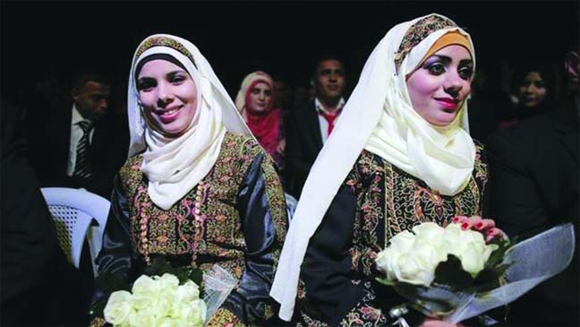 Palestinian brides sit on stage during a mass wedding ceremony in the West Bank city of Jericho.