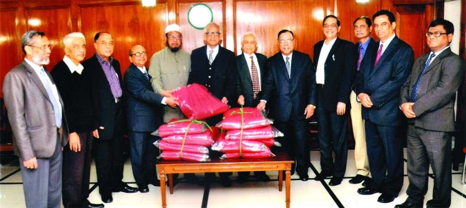 Hafiz Ahmed Mazumder, Chairman of the Board of Directors of Pubali Bank Ltd. handing over 1000 pieces of blankets to Abdus Salam, Chairman of relief committee and Executive Director Kazi Abul Kashem of Anjuman Mufidul Islam for distributing among the poor