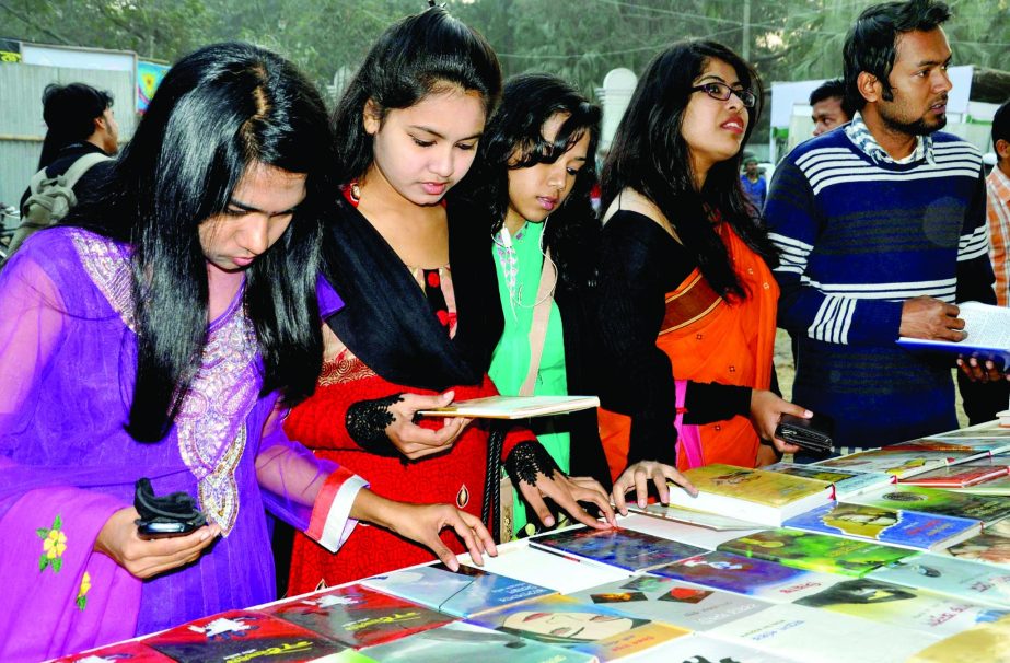 Young Book lovers rush to Amar Ekushey Boi-Mela stalls at Bangla Academy soon after it was inaugurated on Saturday.