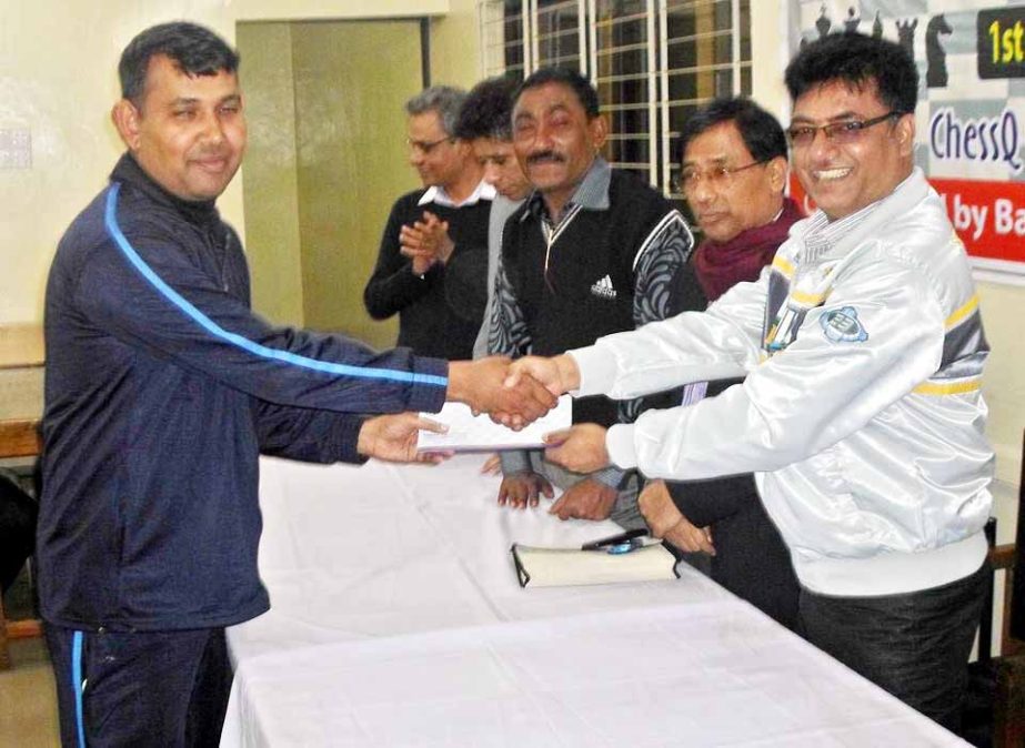 FIDE Master Kh Aminul Islam, the champion of the Chess Q Blitz Rating Chess Tournament receiving the prize from Vice-President of Bangladesh Chess Federation KM Shahidullah at the Bangladesh Chess Federation hall room on Saturday.