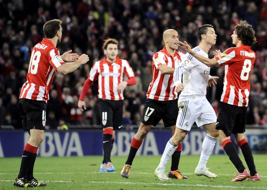 Real Madrid's Cristiano Ronaldo of Portugal, (second right), discusses with Athletic Bilbao's Ander Iturraspe, (right), after swiping his hand across the face of Athletic Bilbao's Carlos Gurpegi, (left), following a shove from his opponent, during the