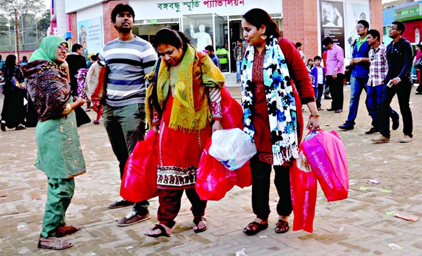 Visitors returning to their residence after buing the essentials at Dhaka International Trade Fair (DITF) stalls on Monday.