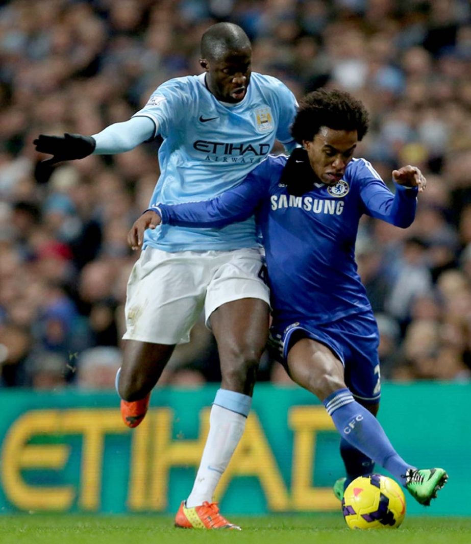 Manchester Cityâ€™s Yaya Toure (left) tackles Chelseaâ€™s Willian during their English Premier League soccer match at the Etihad Stadium, Manchester, England on Monday.