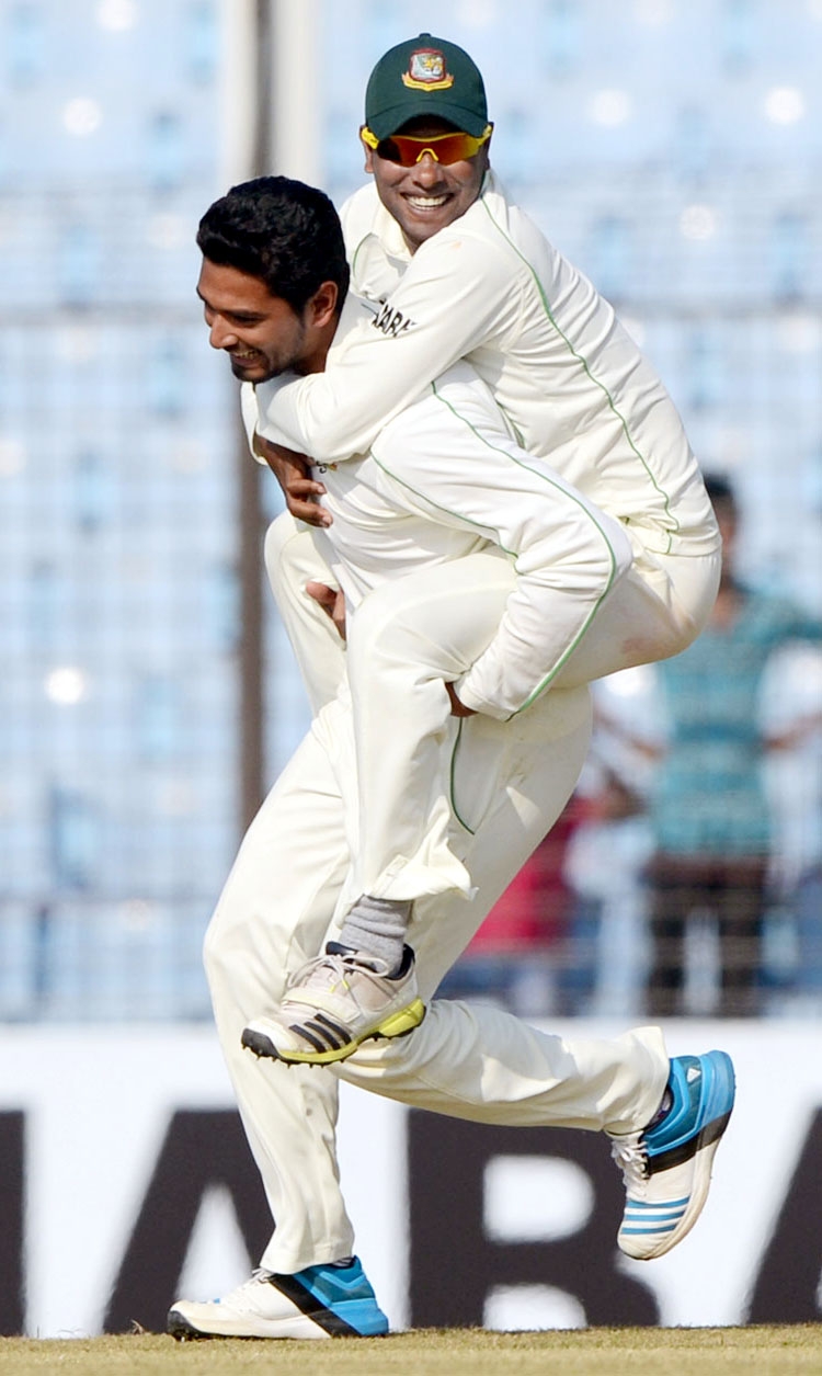 Sohag Gazi jumps on Mahmudullah's back after a Sri Lankan wicket on 1st day of 2nd Test between Bangladesh and Sri Lanka in Chittagong on Tuesday.