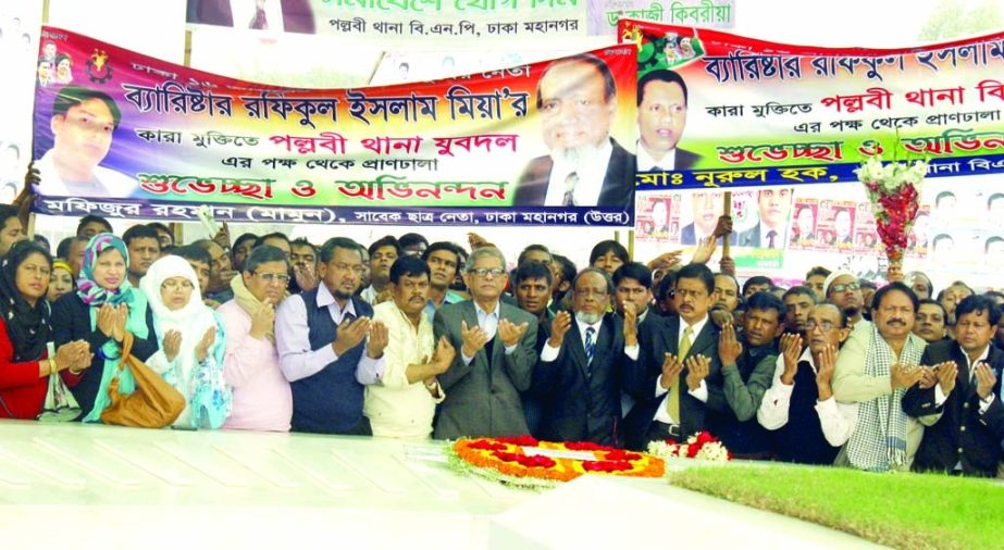 BNP Standing Committee member Barrister Rafiqul Islam Miah along with others offering munajat after placing floral wreaths at the Mazar of Shaheed President Ziaur Rahman in the city on Wednesday after release from jail.