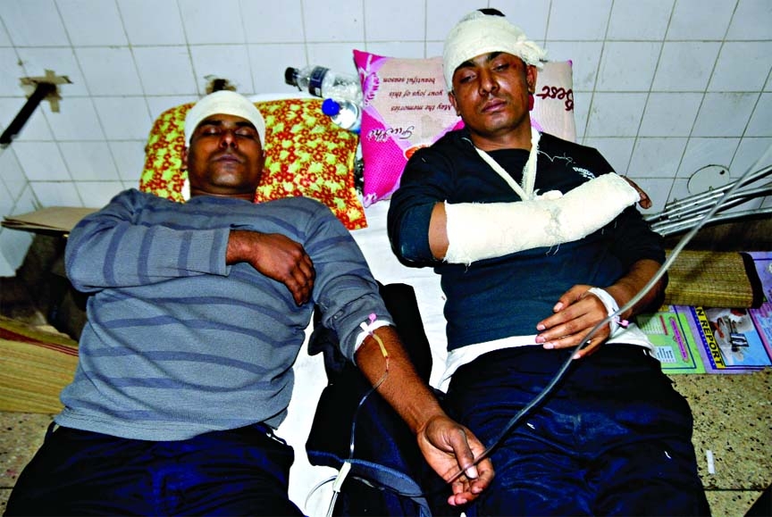 Two seriously injured police constables who suffered wounds in an armed clash with a gang of pirates at river Meghna in Gazaria of Munshiganj district. This photo was taken from DMCH on Wednesday.