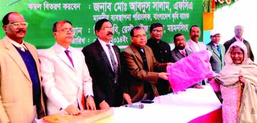 Md Abdus Salam, Managing Director of Bangladesh Krishi Bank distributing blankets among the cold-hit poor people of Khagdaher in Mymensingh recently.