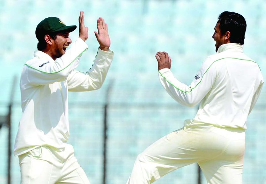 Mahmudullah and Shakib Al Hasan celebrate Mahela Jayawardene's dismissal on the 4th day of 2nd Test between Bangladesh and Sri Lanka in Chittagong on Friday.