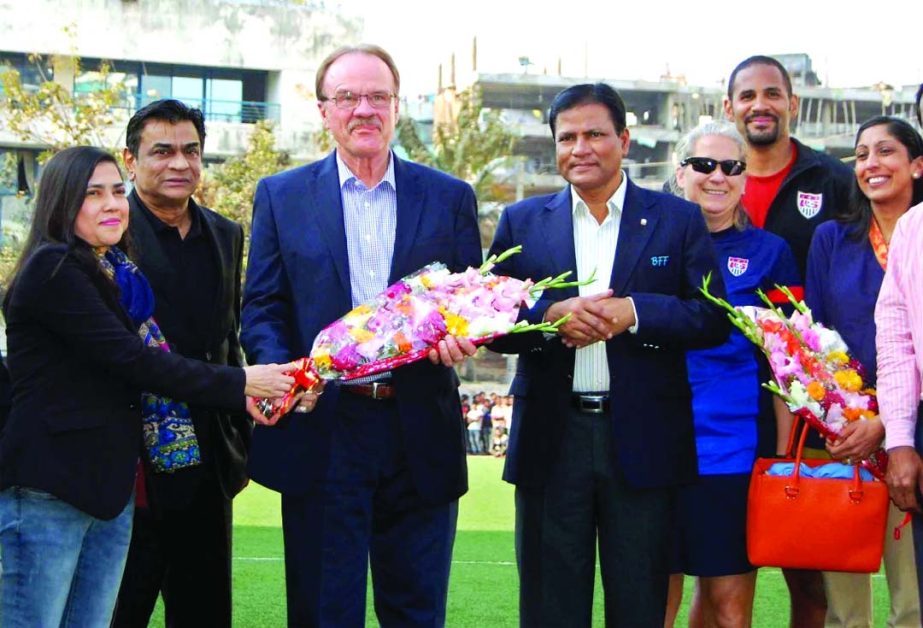 Deputy Chairman of Women's Wing of Bangladesh Football Federation (BFF) Mahfuza Akhter Kiron giving reception to Dan Mozena, Ambassador of the United States of America to Bangladesh with bouquet at the Artificial Turf of BFF on Friday.