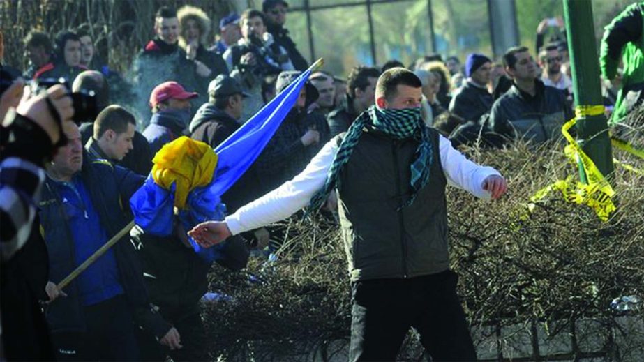 Bosnian protestors try to storm and threw stones a local government building in the Bosnian capital.