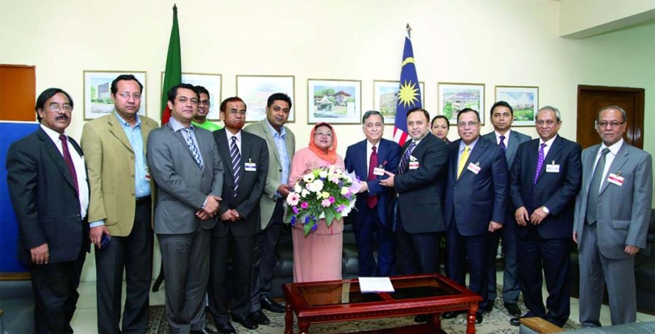 Norlin Binti Othman, Malaysian High Commissioner to Bangladesh and Patron of Bangladesh-Malaysia Chamber of Commerce & Industry (BMCCI) receiving bouquet from Nasir A Choudhury, newly elected President of BMCCI Board of Directors when they call on her at