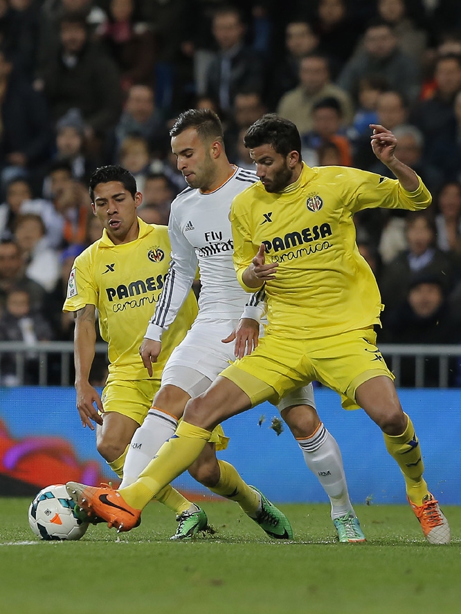 Real Madrid's Jese Rodriguez (centre) in action with Villarreal's Mateo Musacchio (right) and Villarreal's Javier Aquino (left) during a Spanish La Liga soccer match between Real Madrid and Villarreal at the Bernabeu Stadium in Madrid, Spain on Saturda