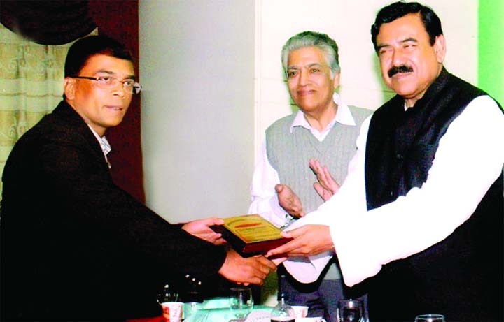 Shipping Minister Md Shajahan Khan handing over crest to Md Kamal Hossain for his special contribution to social work on the occasion of celebrating 22nd anniversary of Bank, Insurance and Industrial Digest at a city hotel recently.