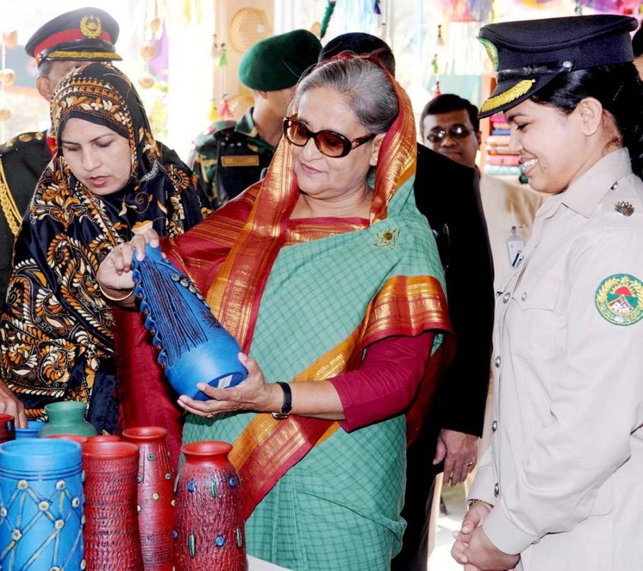 Prime Minister Sheikh Hasina visiting a stall at the Ansar-VDP handicrafts after opening the 34th National Rally at Ansar Academy at Shafipur on Wednesday.