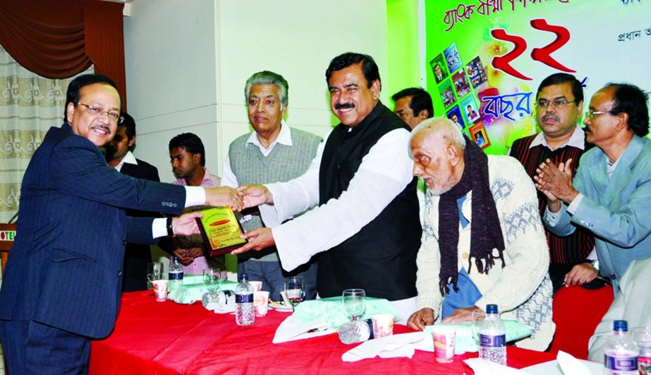Shipping Minister Shajahan Khan handing over Business Award-2013 to Md Ehsan Khasru, Managing Director and CEO of Prime Bank Limited organized by Bank Bima Shilpa Digest at a local hotel recently. Veteran language activist Abdul Matin presided over the fu
