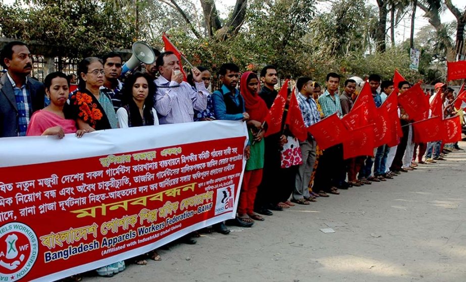 'Bangladesh Poshak Shilpo Sramik Federation' formed a human chain in front of the National Press Club in the city on Friday demanding implementation of new wage board in all garments industries in Bangladesh.