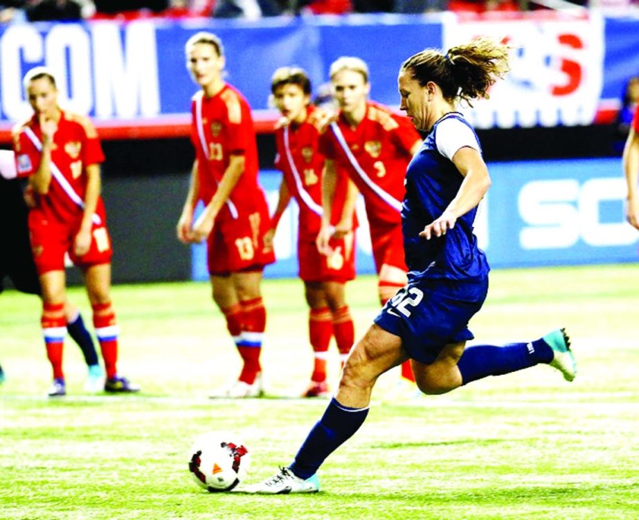 United States' Lauren Holiday (12) scores on a penalty kick in an exhibition soccer match against Russia in Atlanta on Thursday .The United States won 8-0.