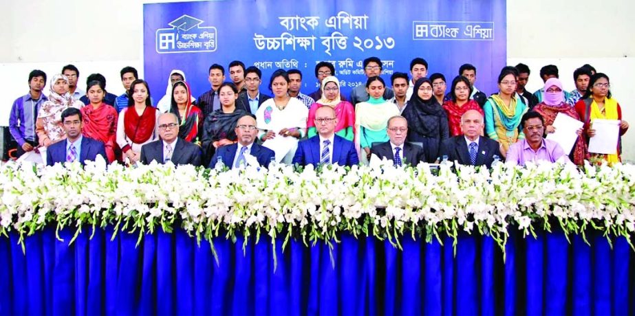 Rumee A Hossain, Chairman of Audit Committee of Bank Asia, handing over Bank Asia Higher Studies Scholarship money to the meritorious students of Chatkhil and Sonaimuri upazilas of Noakhali and Ramganj upazila of Laxmipur at Chatkhil upazila auditorium on