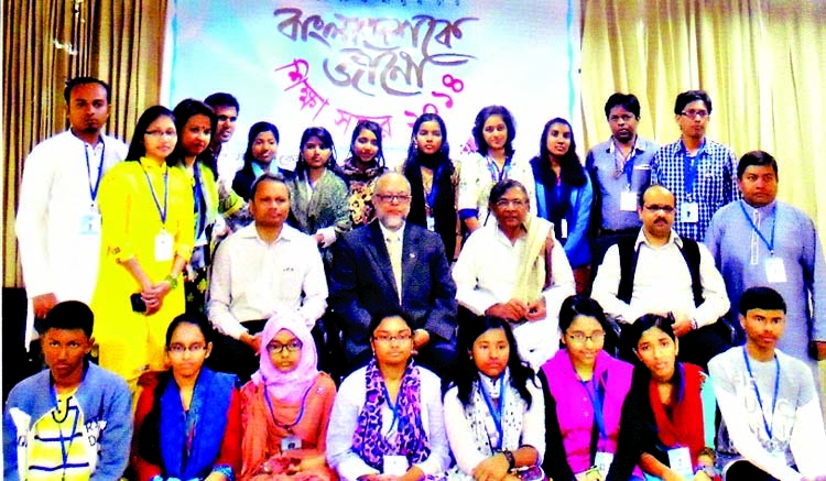 Chairman of Bishwa Sahitya Kendra Abdullah Abu Sayeed along with 15 meritorious students who have been selected for excursion on 'Bangladeshke Jano' pose for photograph at a ceremony held in the city on Friday.